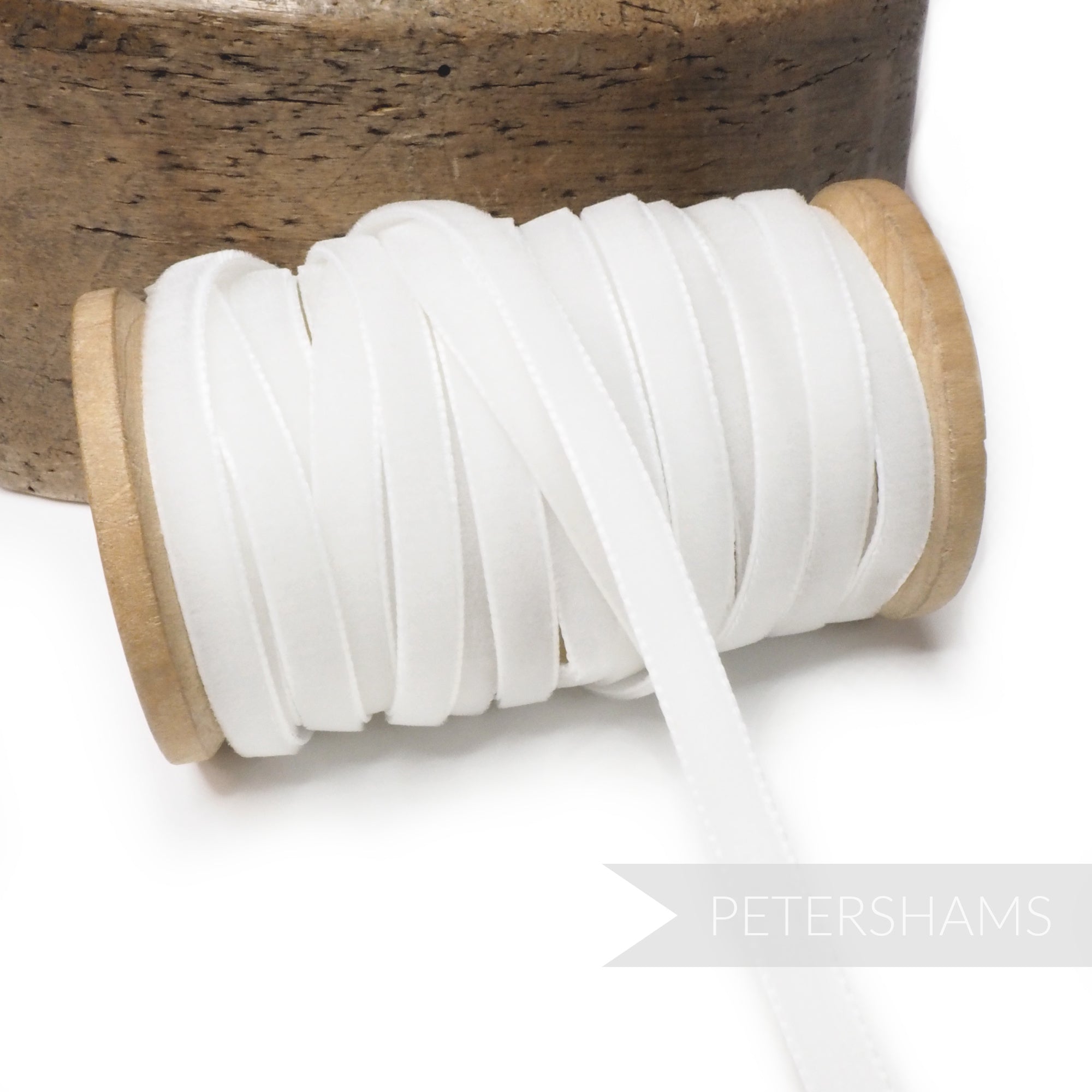 Petershams Millinery Supplies 7mm white vintage rayon velvet ribbon on a wooden spool