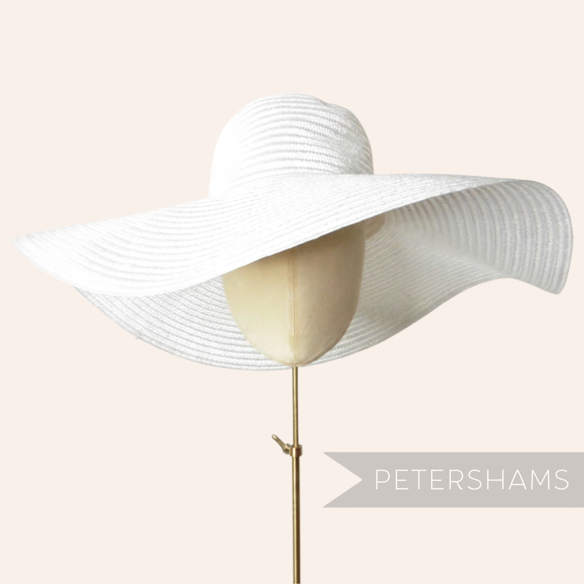 Petershams Millinery Supplies white visca braid capeline hat with an extra large floppy brim on a mannequin head.