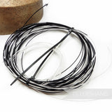 Petershams Millinery Supplies bundle of assorted black and white cotton-covered millinery wire remnants.