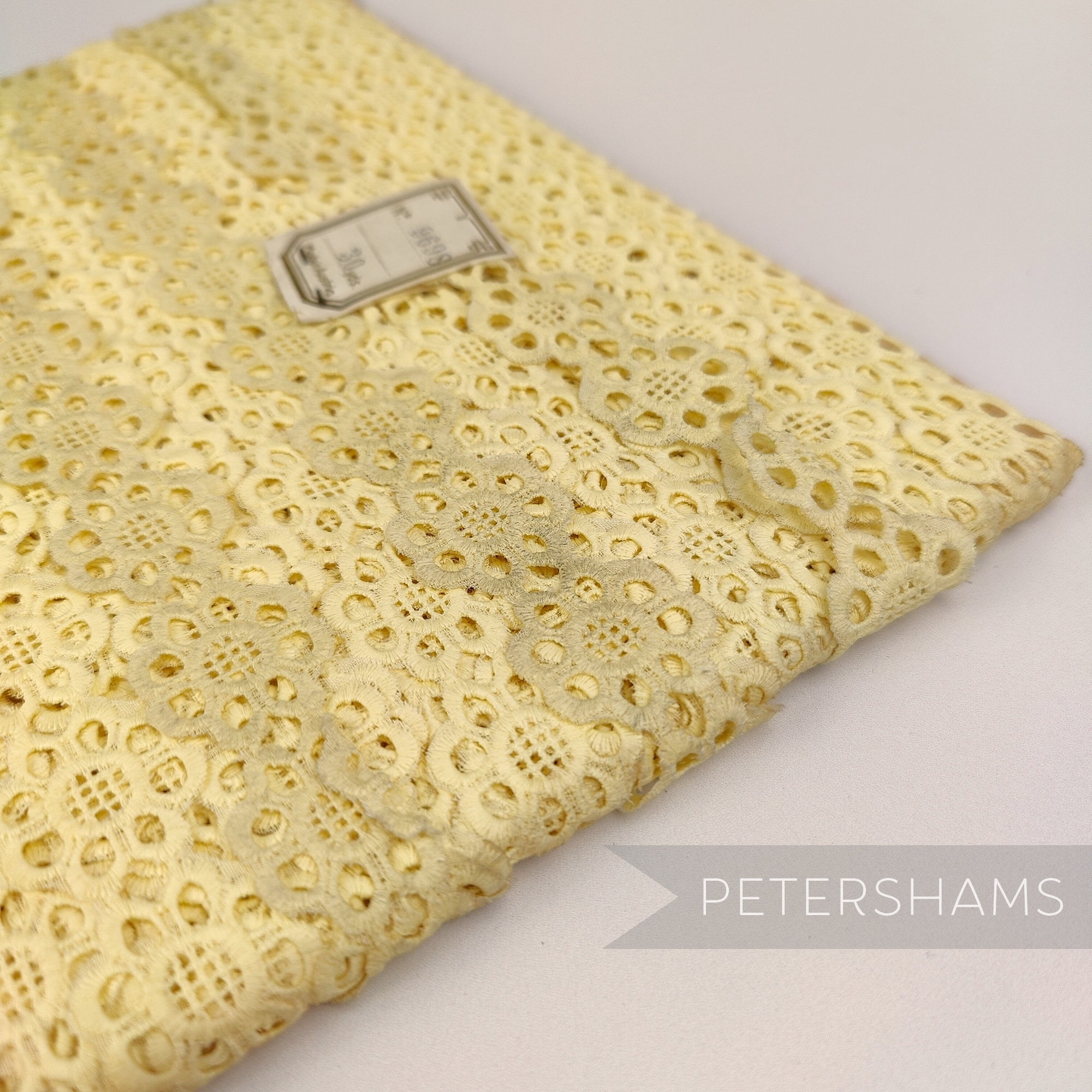 Petershams Millinery Supplies vintage yellow daisy lace trim with 25mm width, showing slight storage marks.