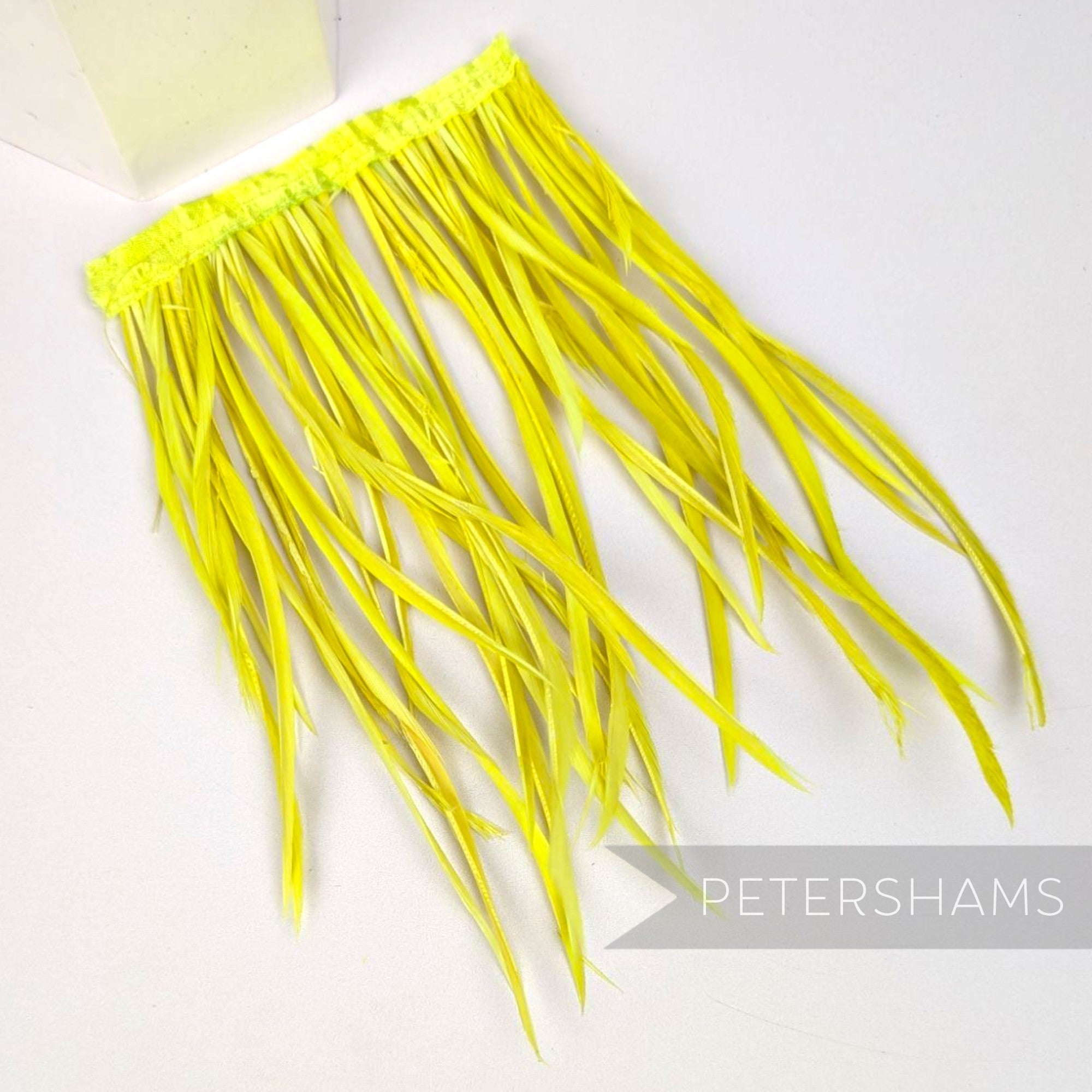 Petershams Millinery Supplies extra long neon yellow goose biot feather fringe on a satin ribbon binding for millinery