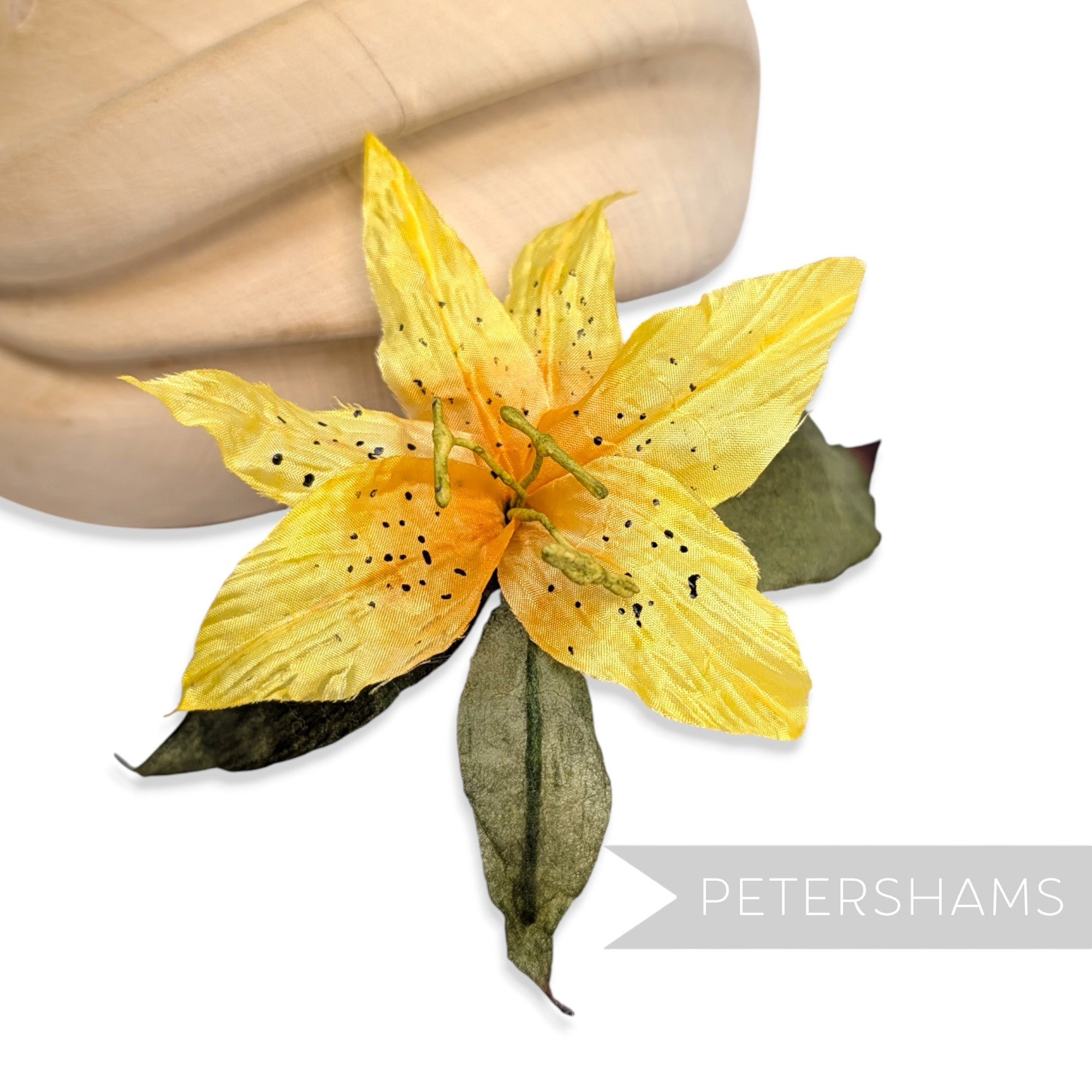 Petershams Millinery Supplies vintage yellow silk lily flower hat mount with hand-painted spots and paper mesh leaves.