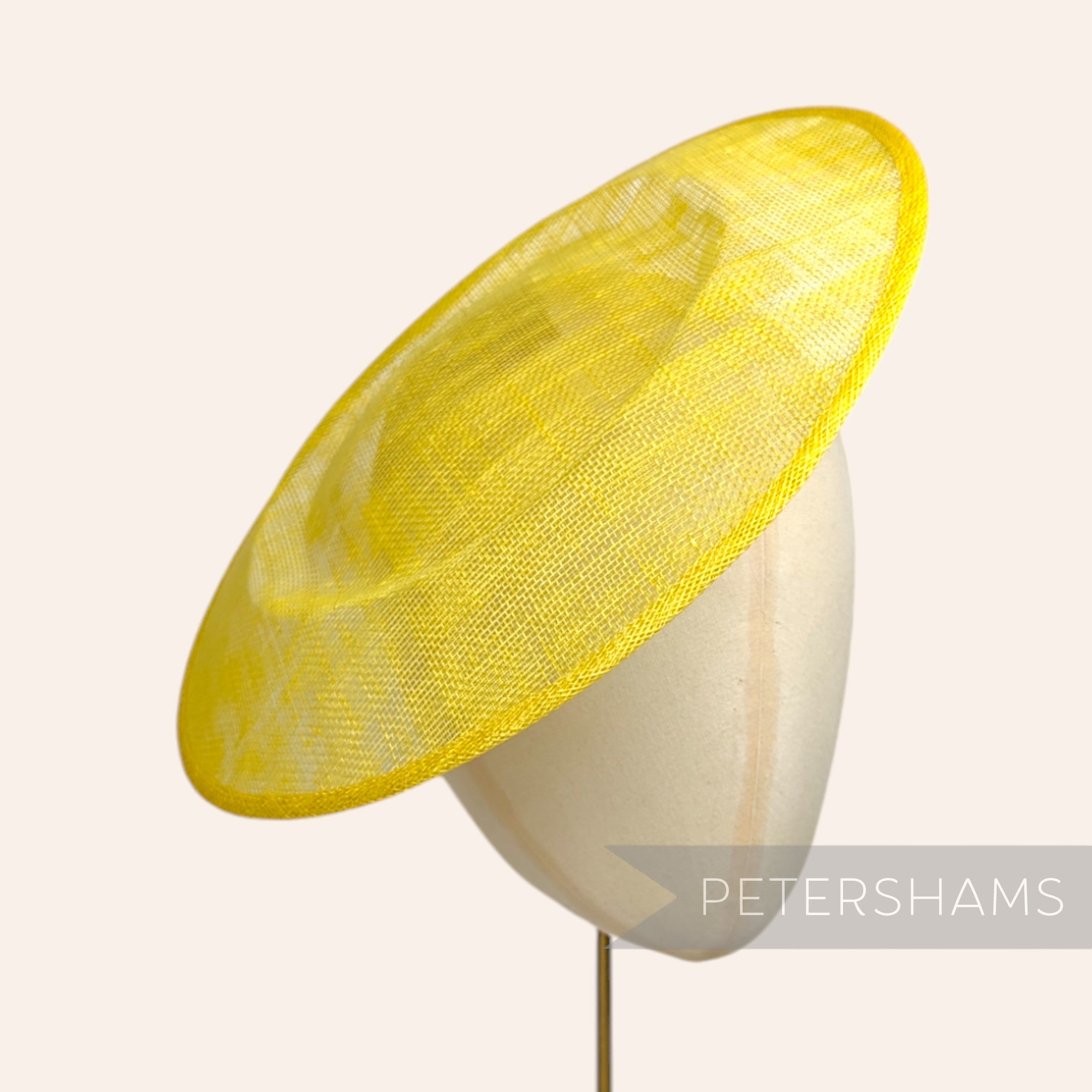 Petershams Millinery Supplies 29cm yellow sinamay saucer fascinator base on a millinery head block