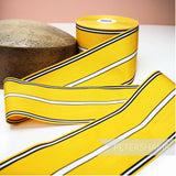 Petershams Millinery Supplies vintage 90mm wide yellow grosgrain ribbon with black and white stripes and moire effect.