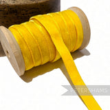 Petershams Millinery Supplies 9mm wide vintage yellow velvet ribbon on a wooden spool for millinery and craft projects.