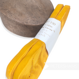 Petershams Millinery Supplies 16mm vintage yellow rayon velvet ribbon on a spool next to a wooden millinery block.