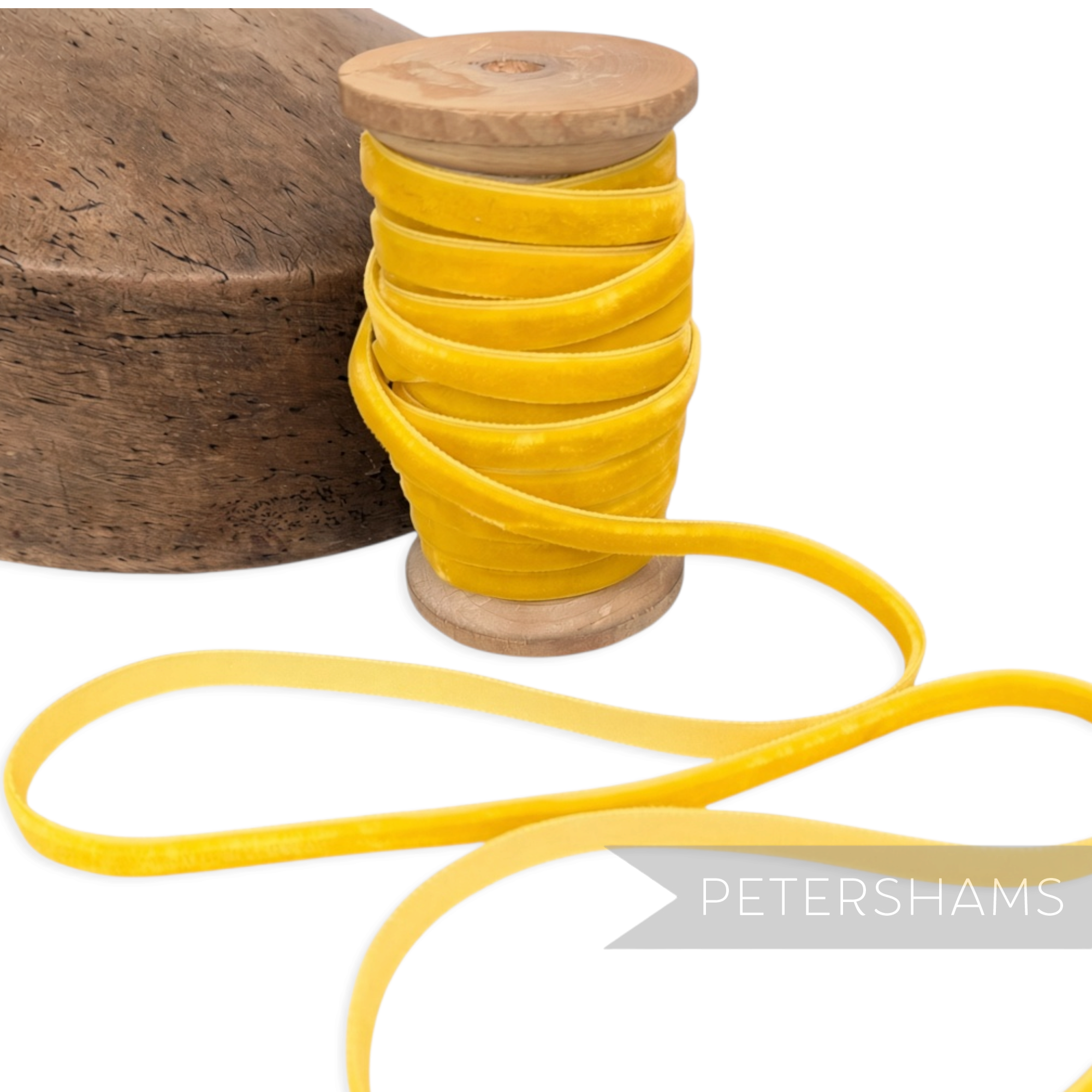 Petershams Millinery Supplies 7mm yellow vintage velvet ribbon on a wooden spool next to a millinery block