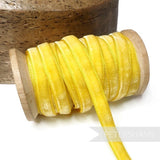 Petershams Millinery Supplies 9mm yellow vintage velvet ribbon on a wooden spool for millinery and craft projects.