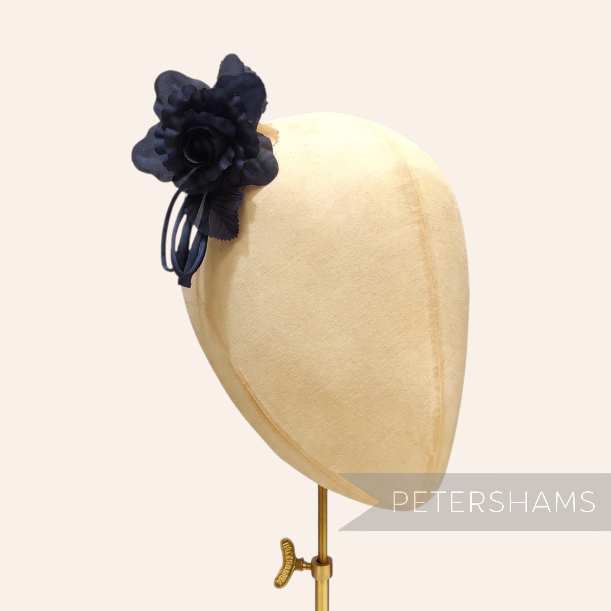 Petershams Millinery Supplies Zahra petite navy blue silk flower hat mount with wired leaves on a millinery head block