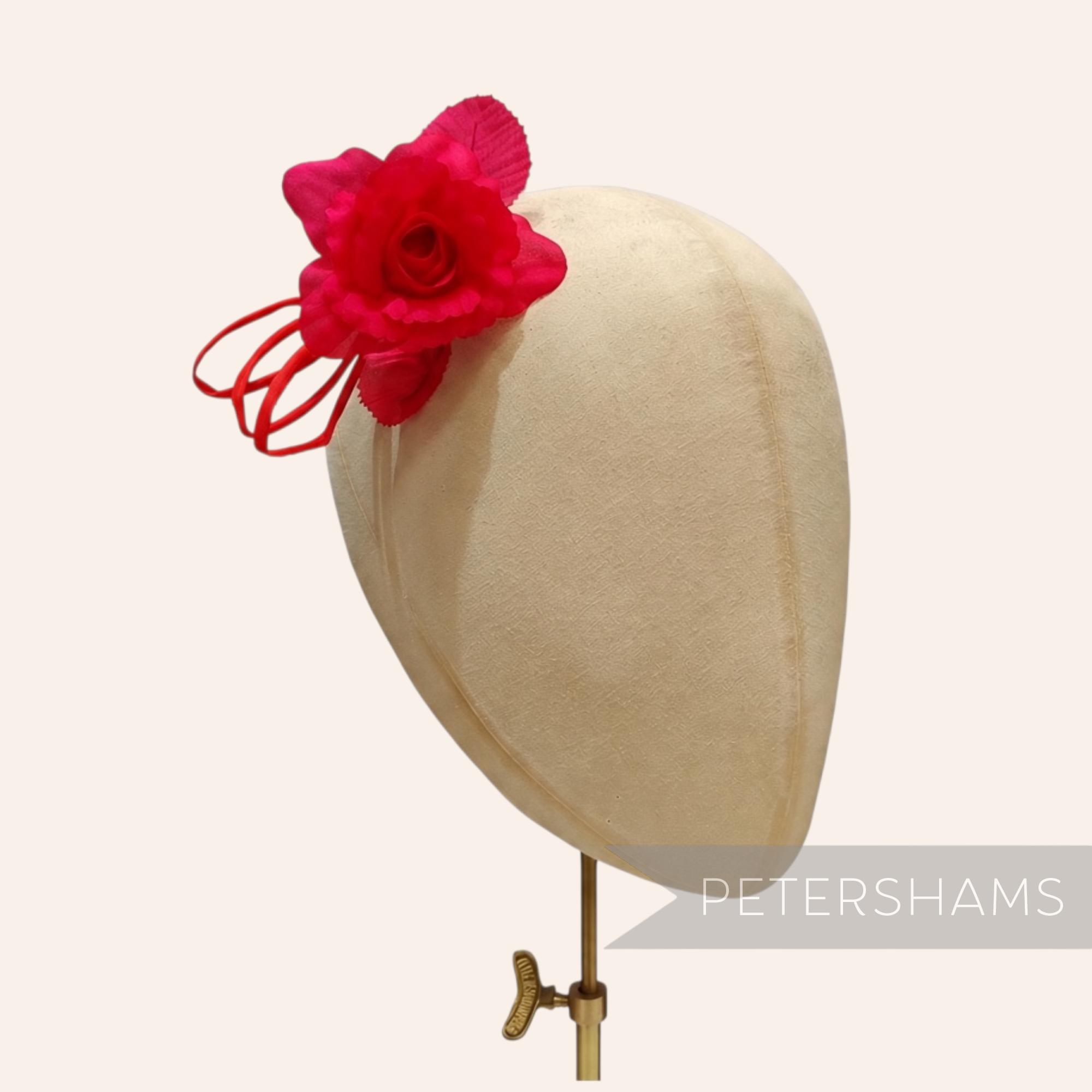 Petershams Millinery Supplies Zahra petite red silk flower hat mount with wired leaves on a millinery head block