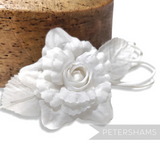 Petershams Millinery Supplies Zahra white silk flower hat mount with wired leaves and loops on a wooden millinery block