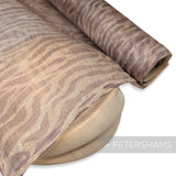 Petershams Millinery Supplies zebra print grey sinamay fabric on a wooden hat block for millinery projects
