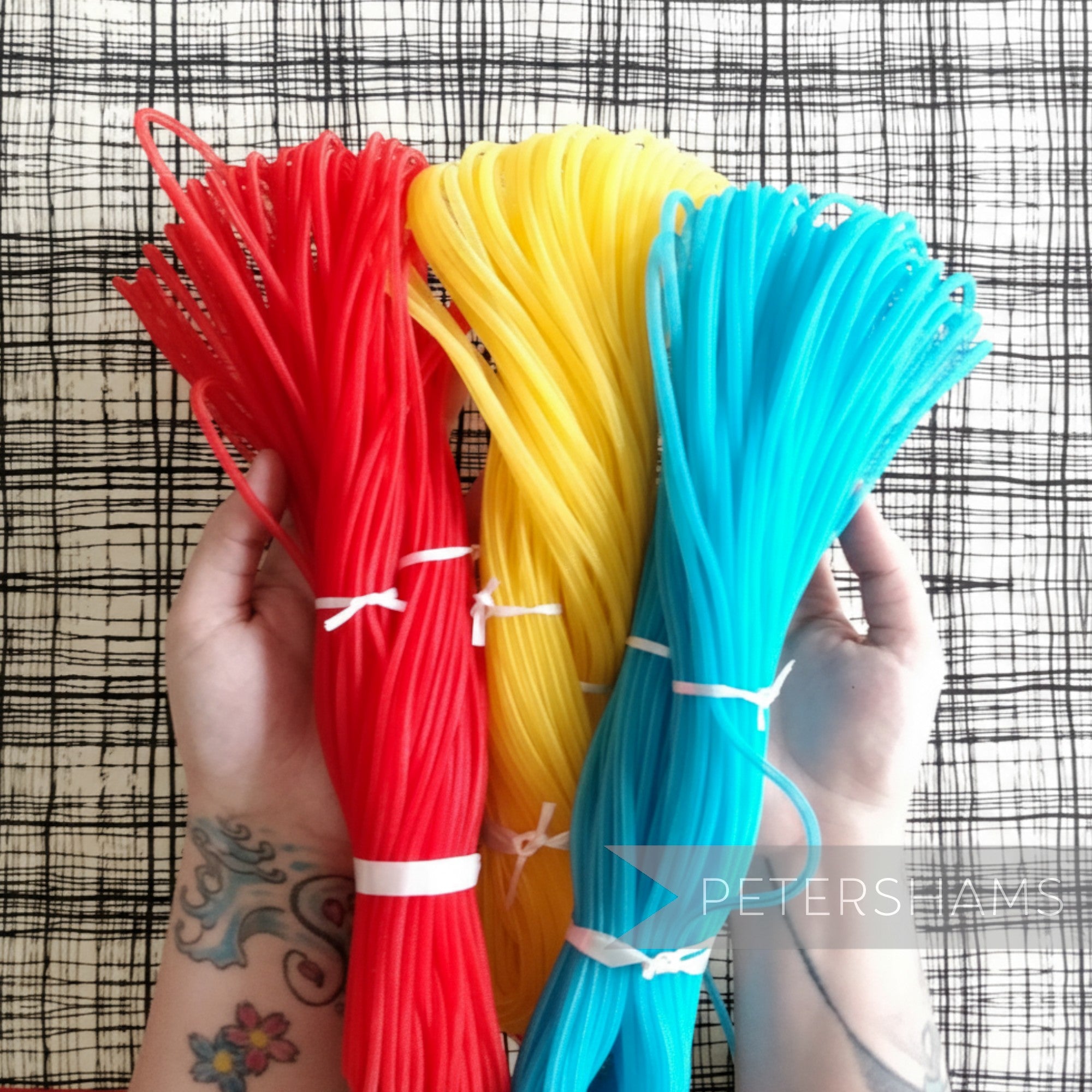 Petershams Millinery Supplies 6mm tube crin in red, yellow, and blue. Ideal for hat making and trims.