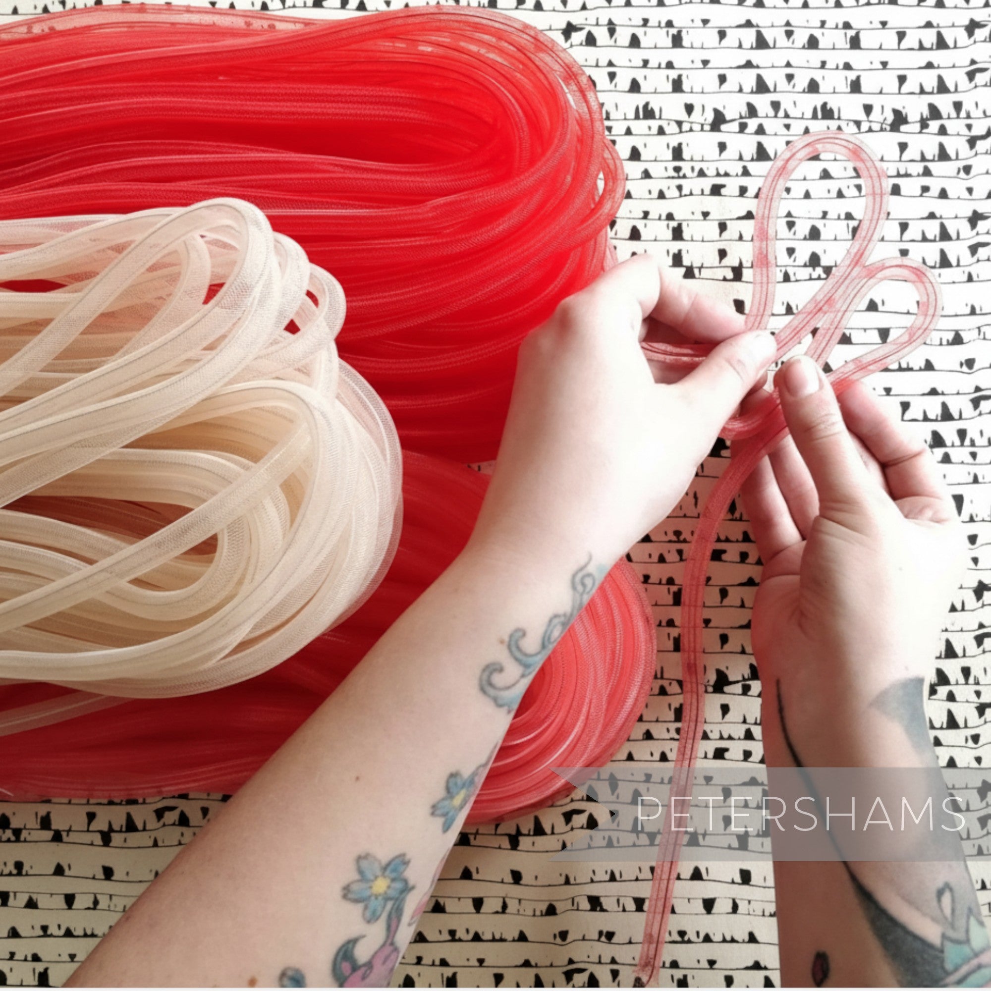 Petershams Millinery Supplies red and cream 8mm tube crin netting for hat making and trims. Flexible and gathered.