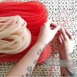 Petershams Millinery Supplies red and cream 8mm tube crin netting for hat making and trims. Flexible and gathered.
