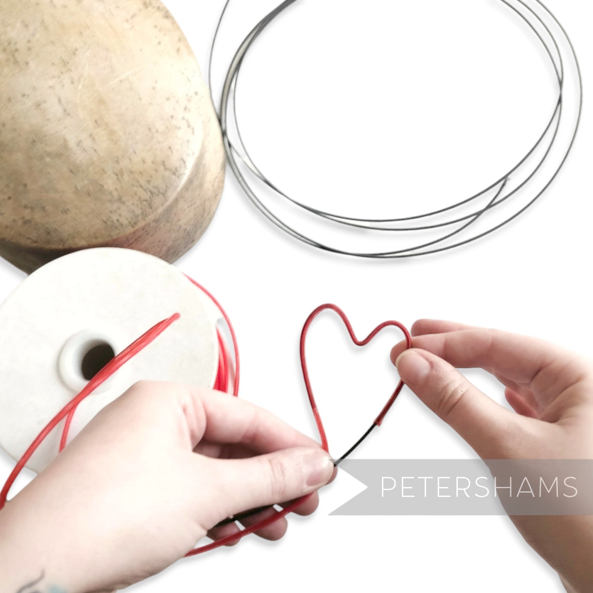 Petershams Millinery Supplies red tubular crin forming a heart shape over black wire for headbands.