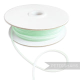 Petershams light mint green 2.5mm tubular millinery crin with central thread for gathering.