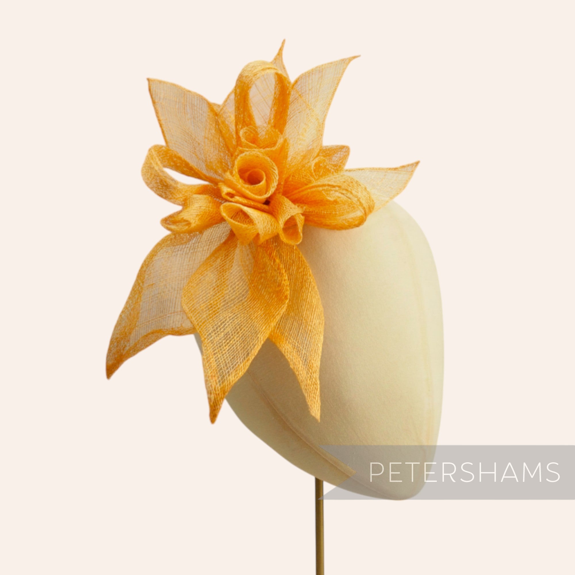 Petershams Millinery Supplies orange sinamay layered flower hat mount with loops and leaves.