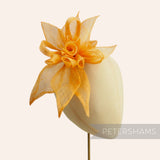 Petershams Millinery Supplies orange sinamay layered flower hat mount with loops and leaves.