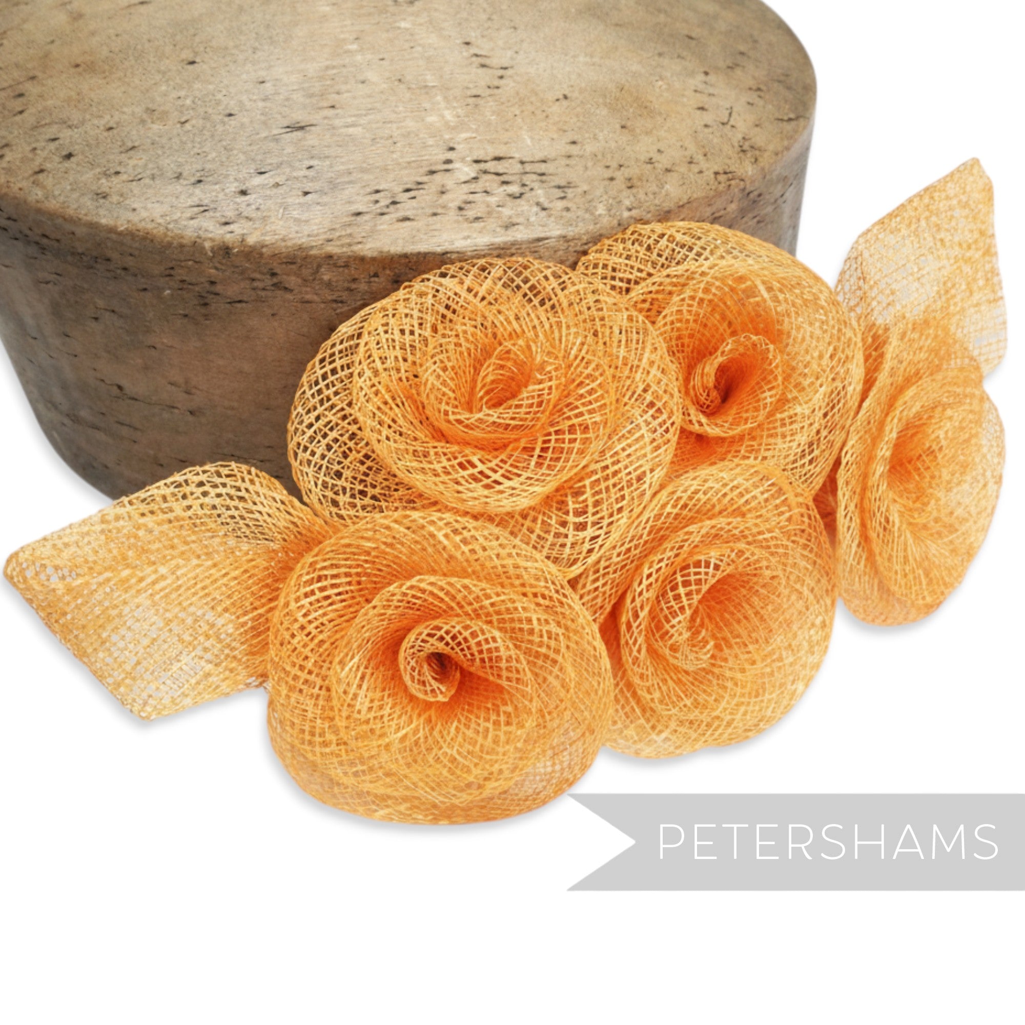 Petershams Millinery Supplies orange sinamay flower and leaf hat trim mount, 20cm wide.