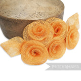 Petershams Millinery Supplies orange sinamay flower and leaf hat trim mount, 20cm wide.