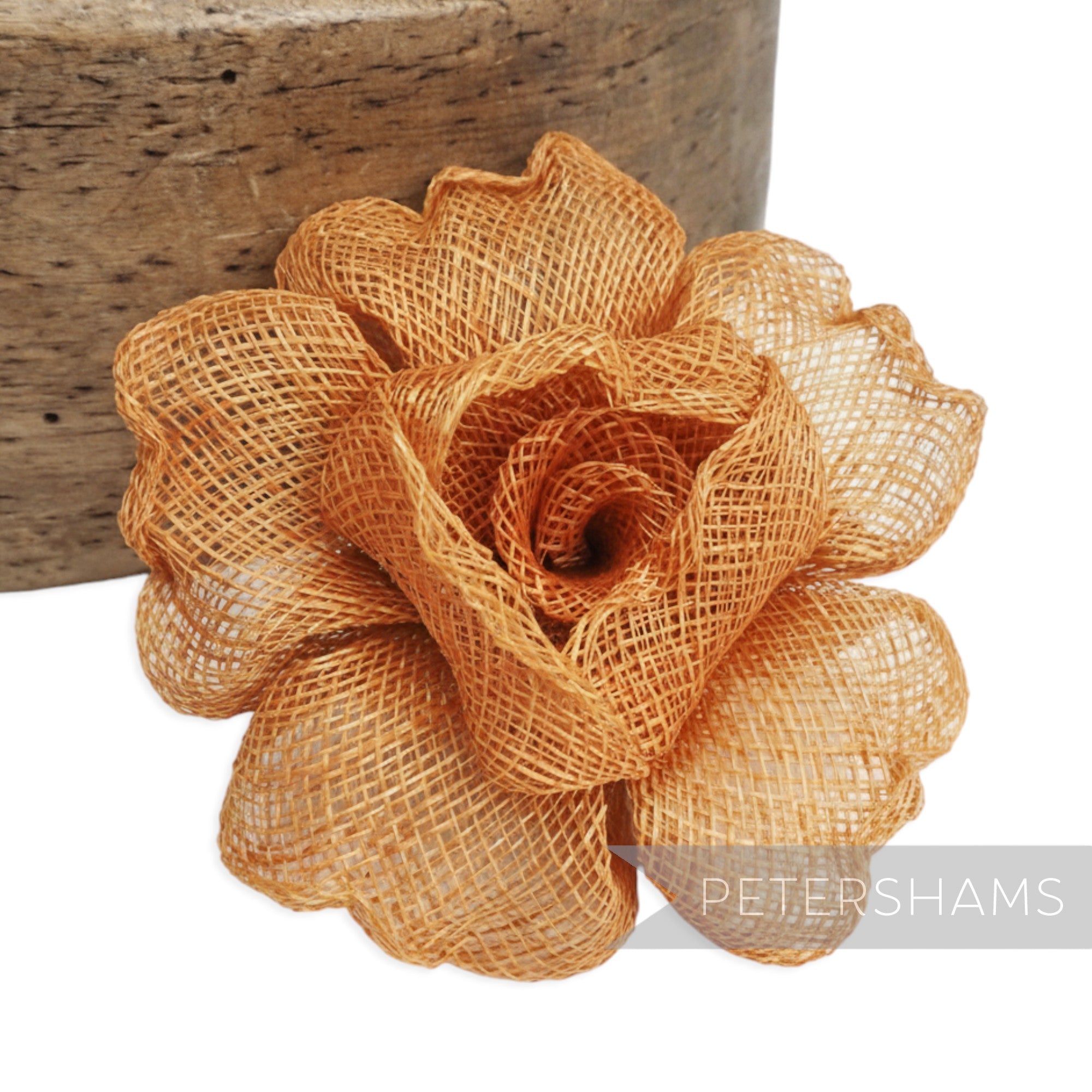 Petershams Millinery Supplies orange crimped sinamay flower hat mount, 9-10cm wide.