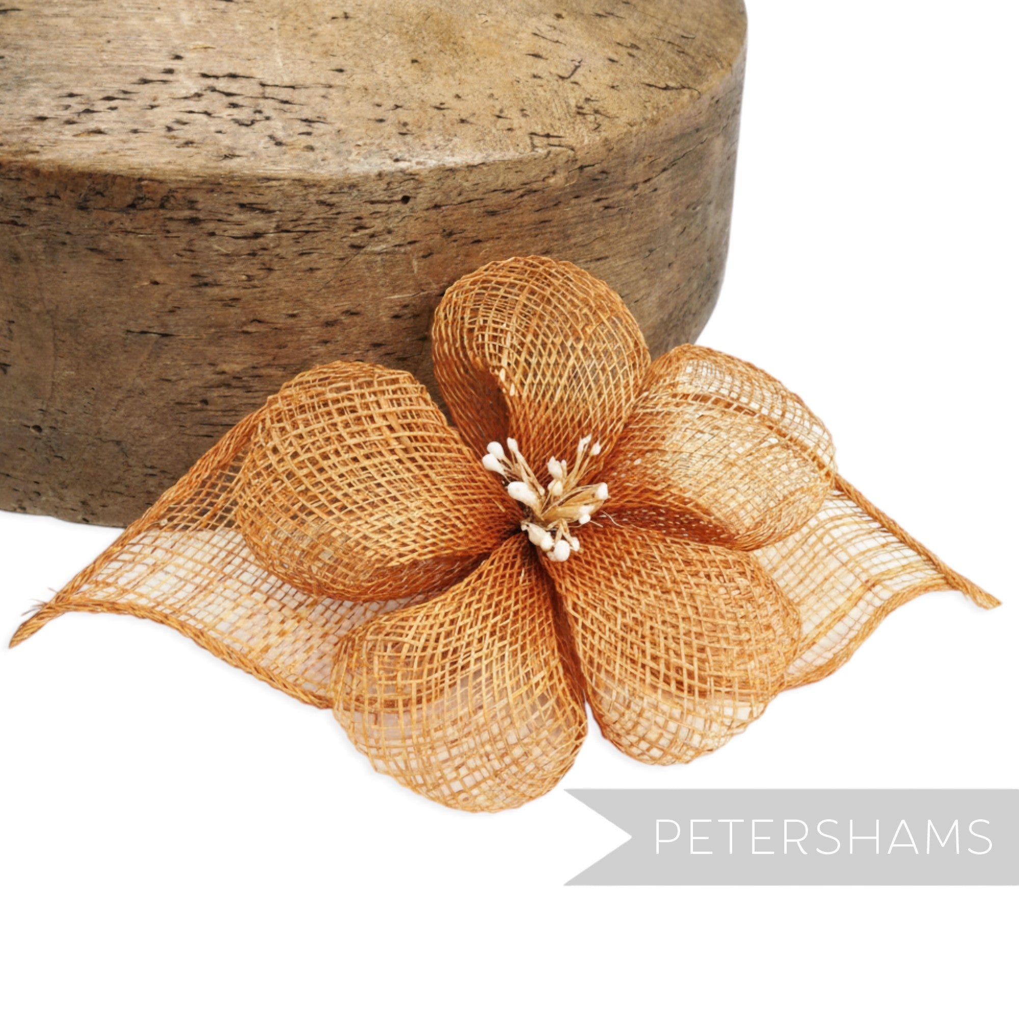 Petershams Millinery Supplies orange sinamay hibiscus flower hat mount with rolled leaves and stamens.