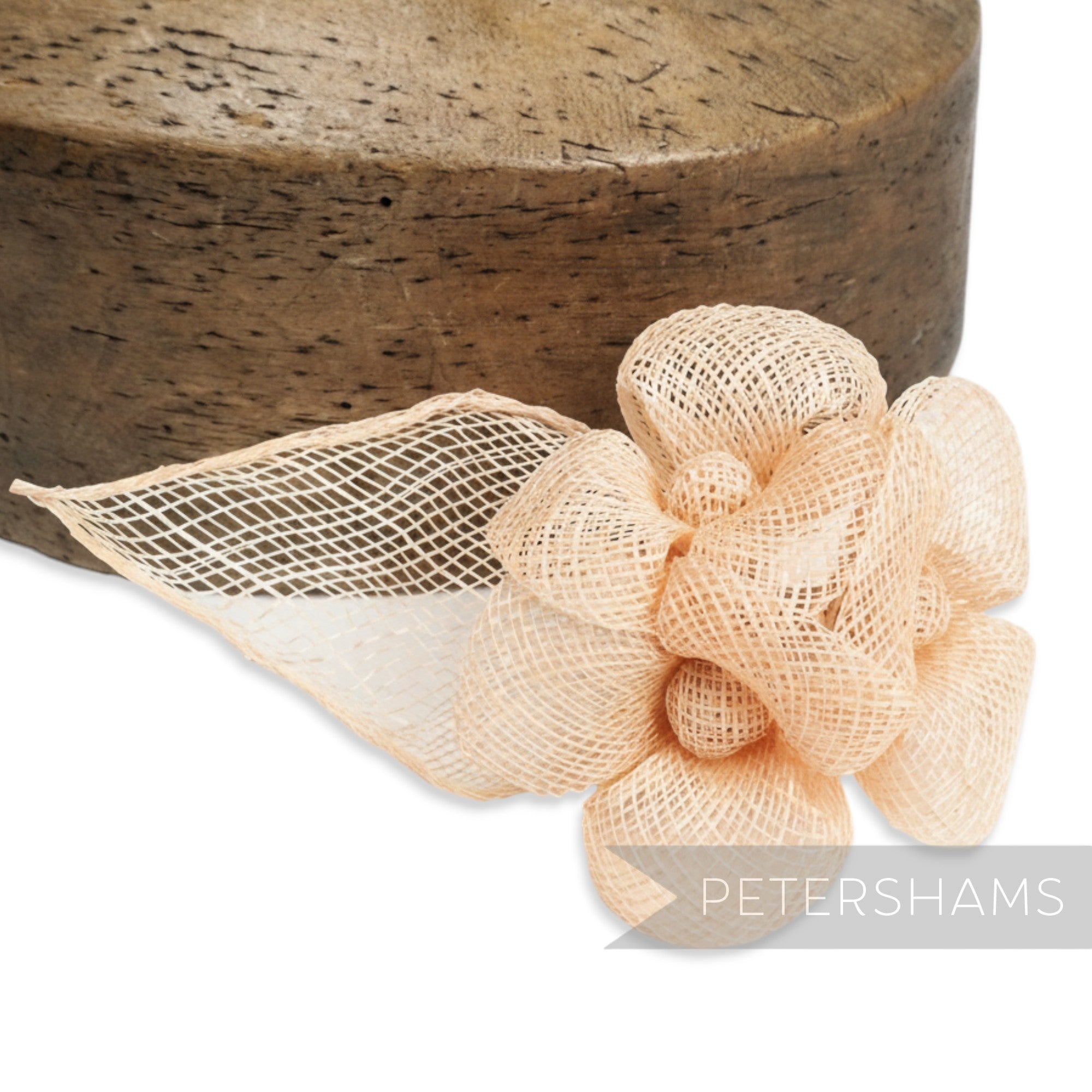Petershams Millinery Supplies pale peach sinamay hat mount with triple flowers and leaf detail.