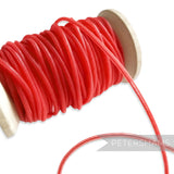 Petershams red 2.5mm tubular millinery crinoline cord on a wooden spool, ideal for headbands.