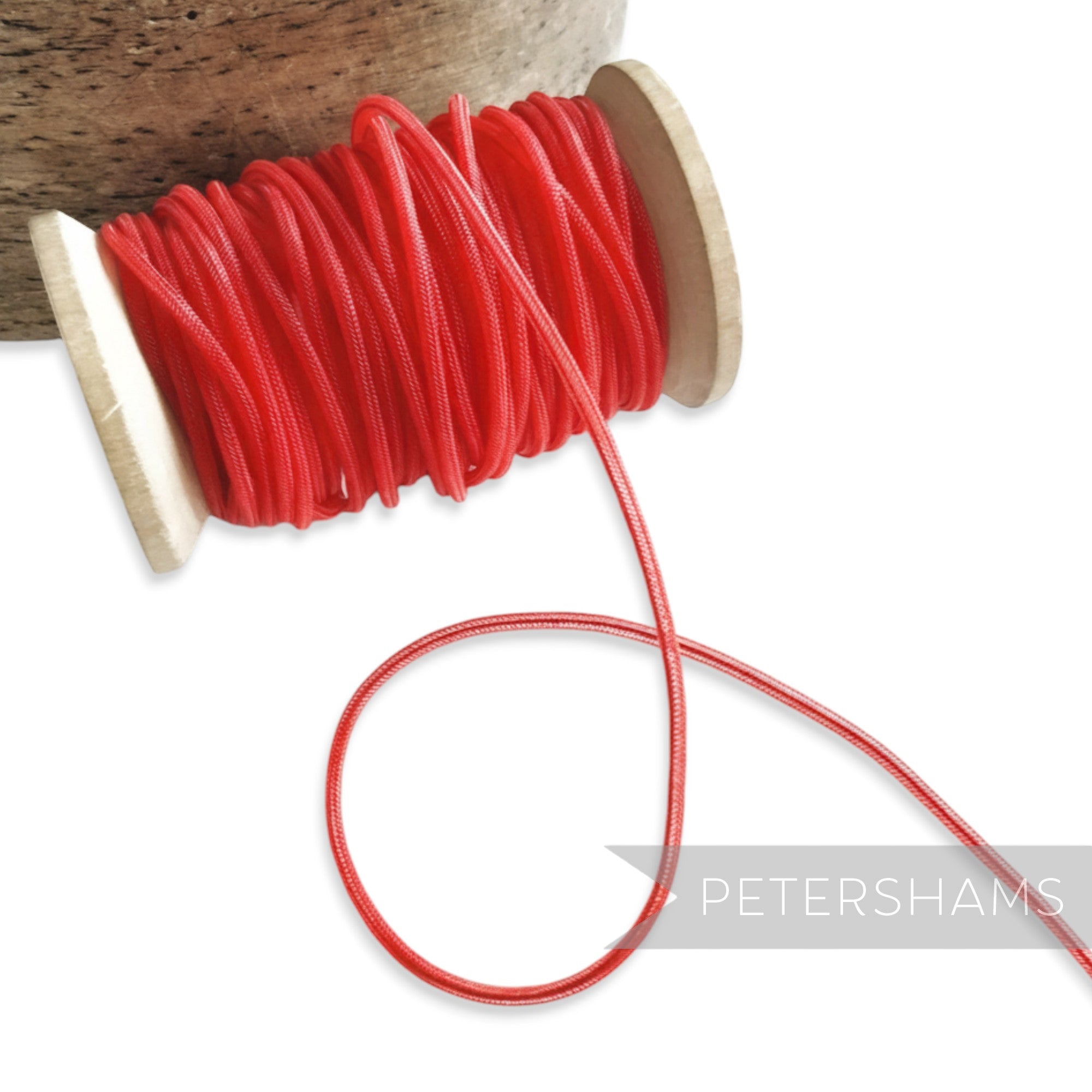 Petershams red 2.5mm tubular millinery crinoline cord with a central thread for gathering.