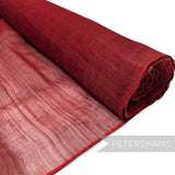 Petershams Millinery Supplies red polyester abaca fabric with a slightly glossy, rustic texture and wavy threading. Ideal for bows and loops.