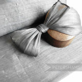 Petershams Millinery Supplies silver polyester abaca fabric with a slight sheen, woven with polyester threads for a rustic look.