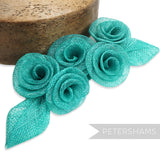 Petershams Millinery Supplies teal sinamay abaca flower and leaf hat mount. Five roses with two leaves.