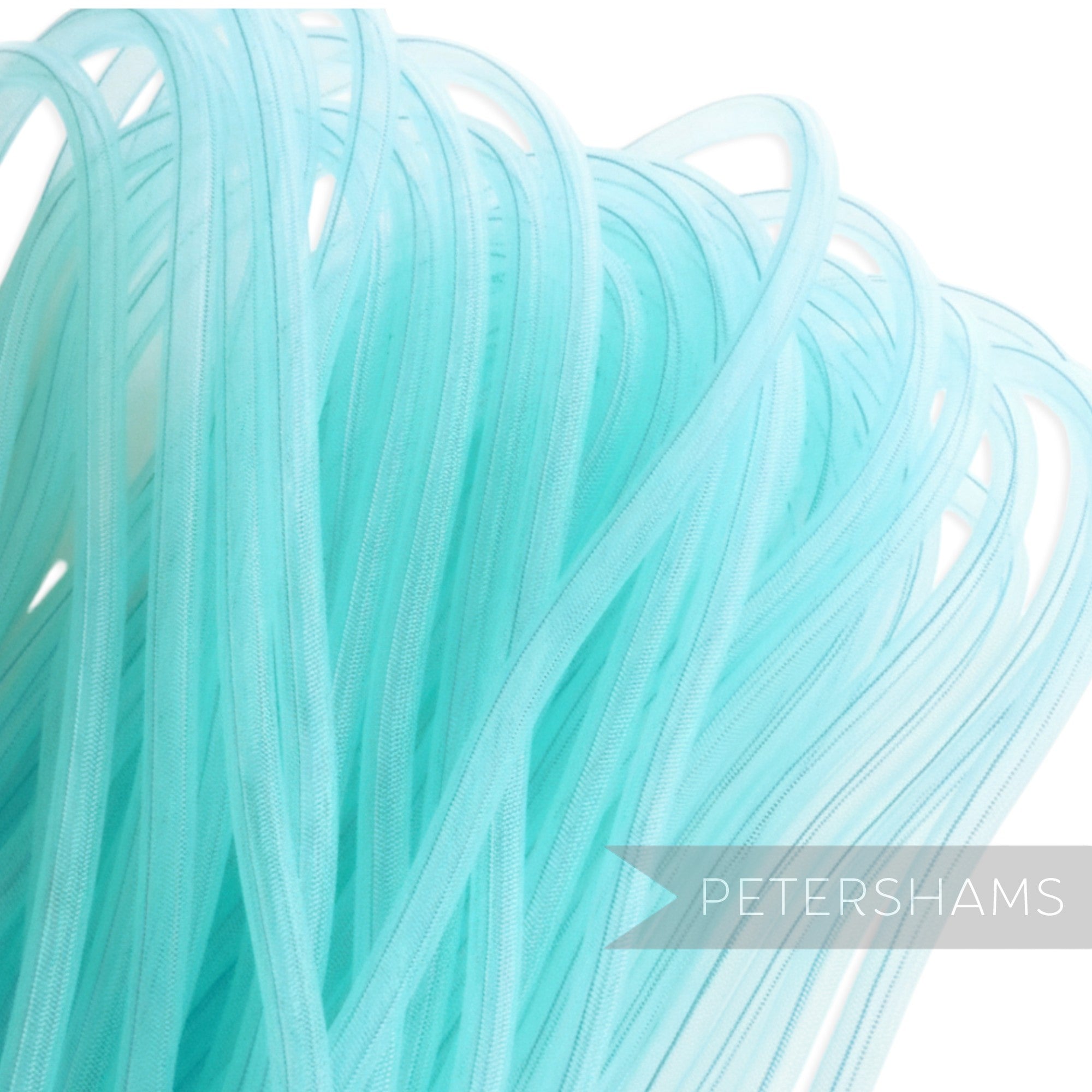 Petershams turquoise 8mm tube millinery crin with gathered threads, ideal for hat making and trims.
