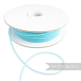 Petershams Millinery Supplies turquoise tubular crinoline, 2.5mm wide, with a central thread for gathering.