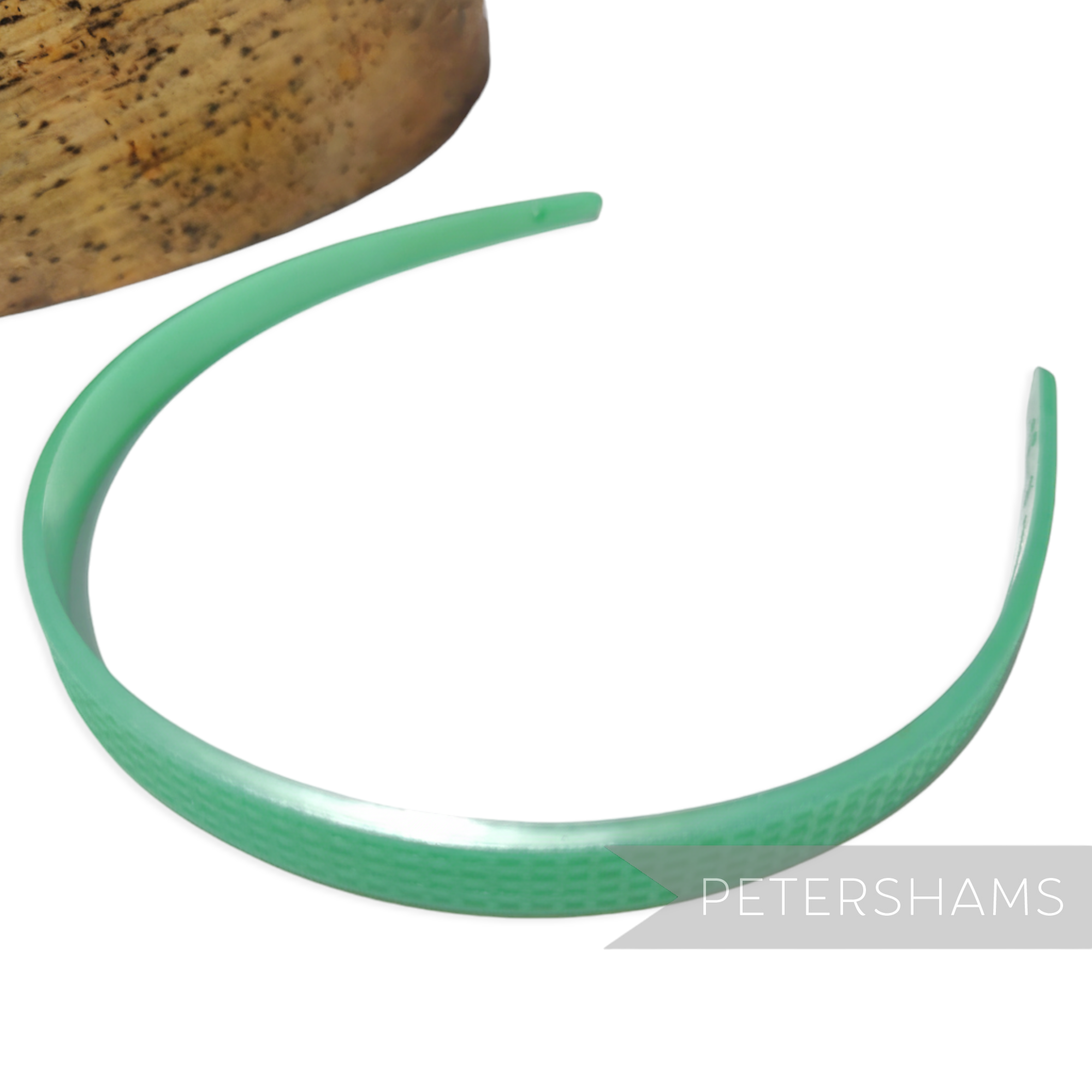 Petershams Millinery Supplies vintage green 8mm skinny headband with fine grid pattern and small holes for attachments.