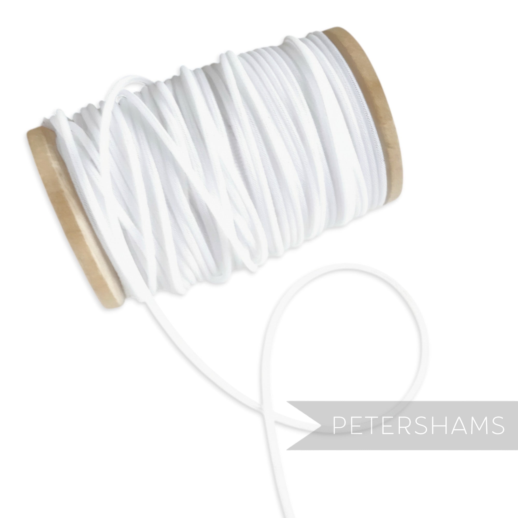 Petershams white 2.5mm tubular millinery crin on a wooden spool, ideal for headbands and graphic shapes.