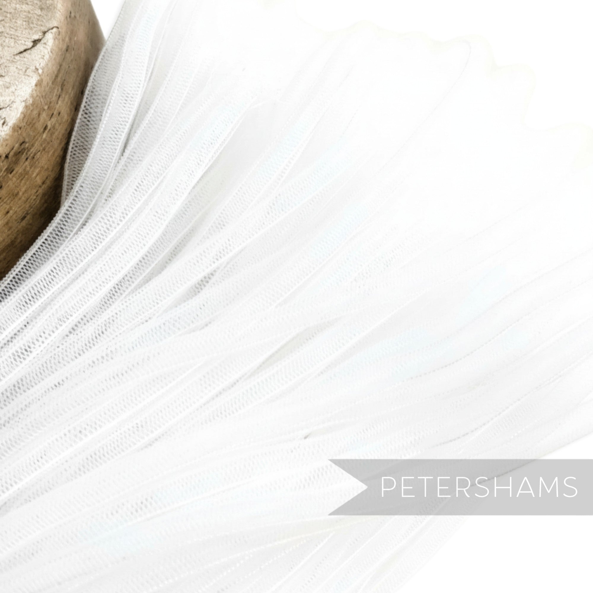Petershams white 6mm tube crin netting, ideal for hat making and trims. Slightly sheer with gathered threads.