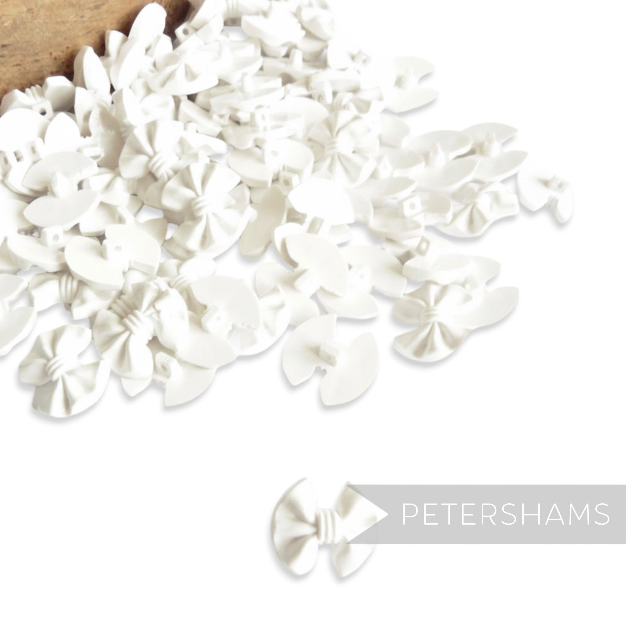 Petershams Millinery Supplies vintage white plastic bow buttons with central back shank, 20mm.