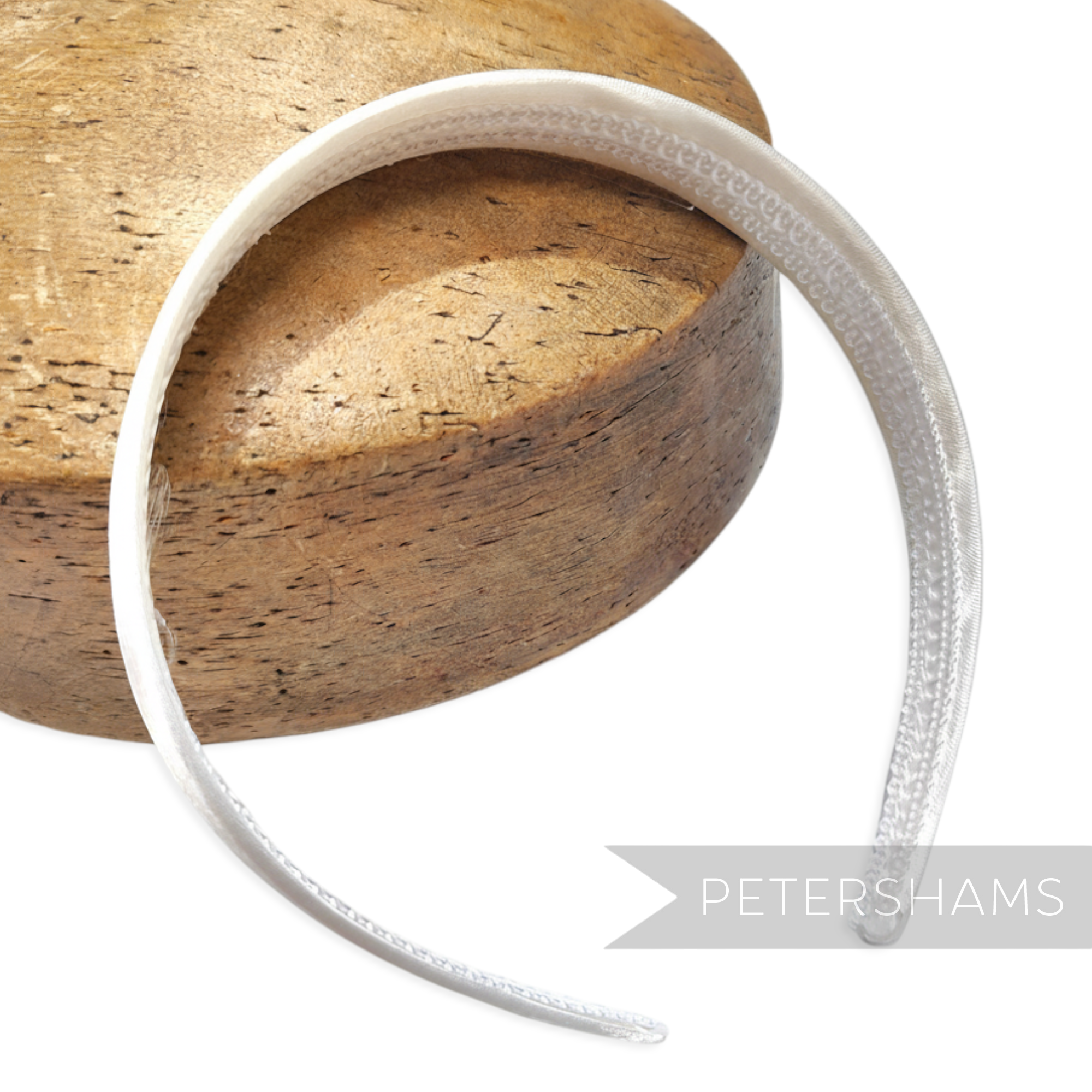 Petershams white satin covered plastic headband, 24mm wide flat base, ideal for millinery.