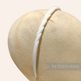Petershams Millinery Supplies vintage 1960s white skinny headband with swirl pattern and grip spikes.