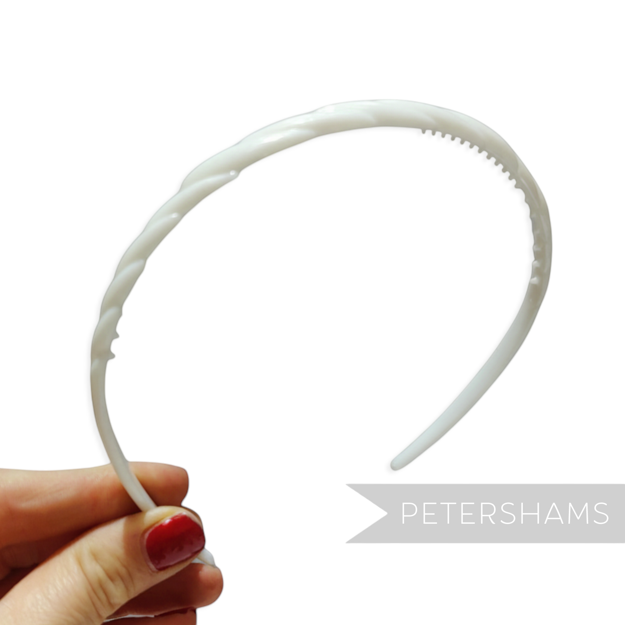 Petershams white vintage 1960s skinny headband with swirl pattern and grip spikes.