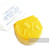 Petershams yellow vintage Presto sewing set in plastic case with sewing motifs. Includes needles, threader, thimble, and more.