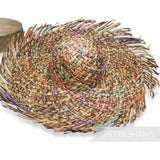 Petershams Millinery Supplies dark straw capeline with a fringed brim and colorful woven rope accents.